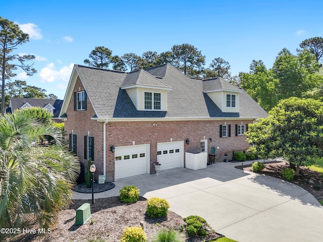 view of property exterior featuring driveway, brick siding, roof with shingles, and a garage