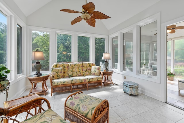 sunroom featuring vaulted ceiling, tile patterned flooring, and baseboards