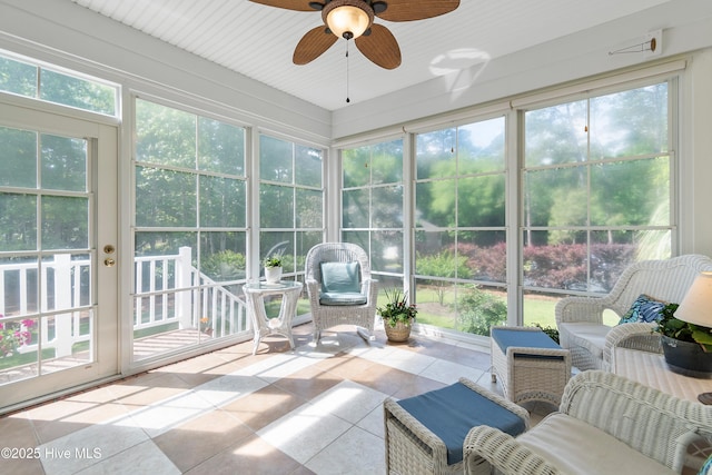 sunroom featuring ceiling fan and french doors