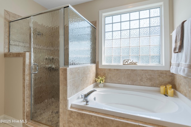 full bathroom featuring a stall shower and a garden tub