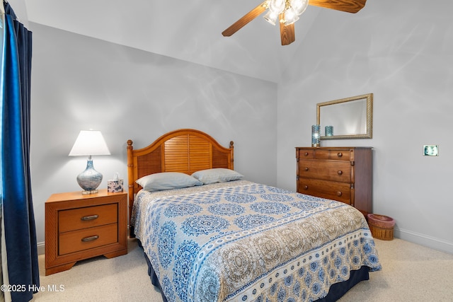 carpeted bedroom with lofted ceiling, baseboards, and ceiling fan