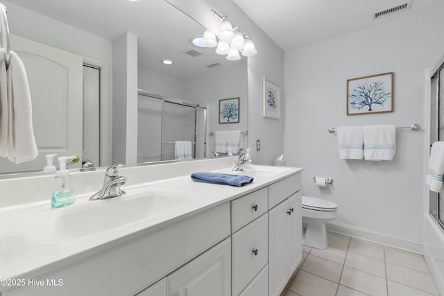 bathroom featuring a shower with shower door, baseboards, tile patterned flooring, toilet, and double vanity