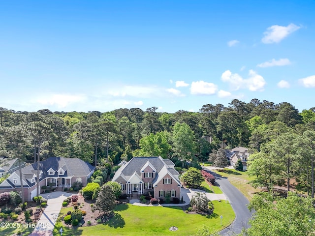 view of subject property with a forest