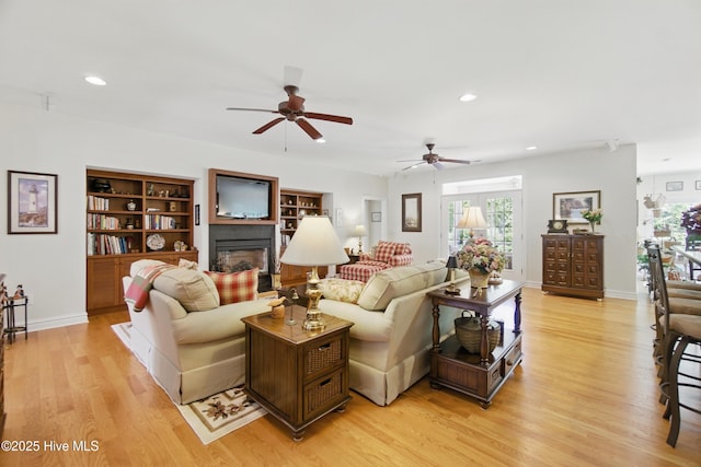 127 Meherrin River Dr, Hertford, NC 27944 - living room featuring light wood-style floors, ceiling fan, plenty of natural light, recessed lighting, and a glass covered fireplace