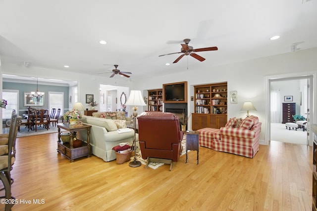 127 Meherrin River Dr, Hertford, NC 27944 - living area featuring light wood-type flooring, recessed lighting, a ceiling fan, a chandelier, and a fireplace