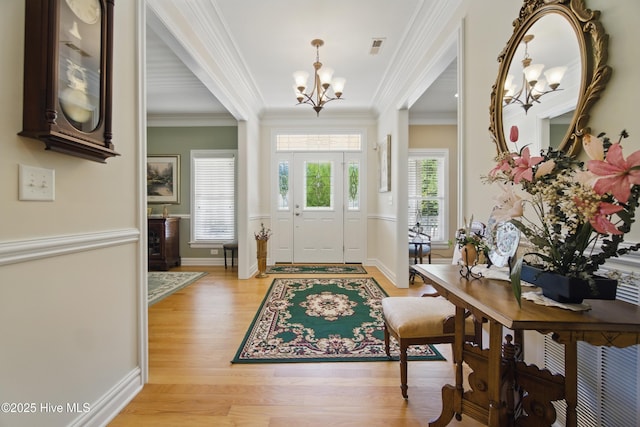 127 Meherrin River Dr, Hertford, NC 27944 - entrance foyer with a chandelier, light wood-type flooring, ornamental molding, and baseboards