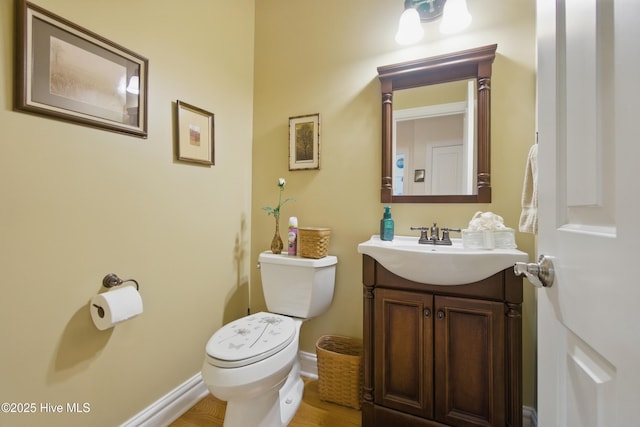 127 Meherrin River Dr, Hertford, NC 27944 - bathroom with vanity, toilet, wood finished floors, and baseboards