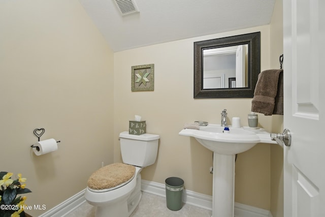 127 Meherrin River Dr, Hertford, NC 27944 - half bathroom featuring toilet, baseboards, lofted ceiling, and tile patterned flooring