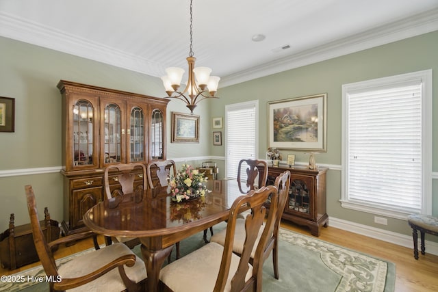 127 Meherrin River Dr, Hertford, NC 27944 - dining area with a chandelier, ornamental molding, light wood-style floors, and baseboards