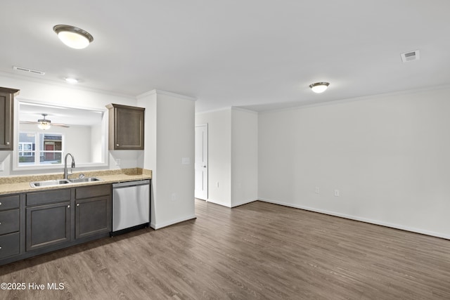 kitchen with stainless steel dishwasher, a sink, wood finished floors, crown molding, and ceiling fan
