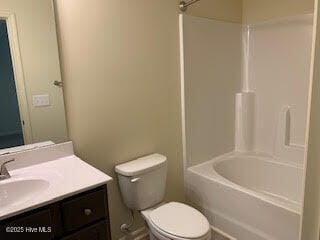 full bathroom with toilet, vanity, and shower / washtub combination