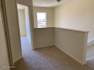 hall with carpet floors and baseboards