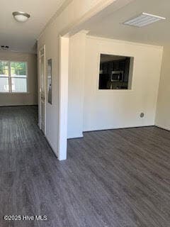 spare room featuring dark wood finished floors