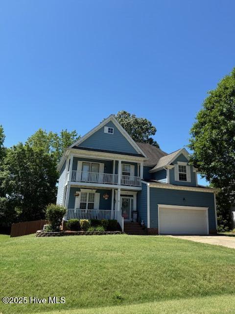 neoclassical home with driveway, a balcony, an attached garage, and a porch