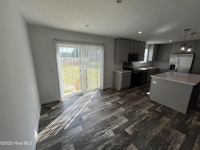 6243 NC Highway 58, Stantonsburg, NC 27883 - kitchen with stainless steel appliances, gray cabinetry, a textured ceiling, dark wood-style flooring, and light countertops