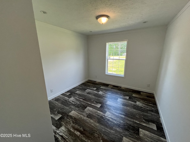 6243 NC Highway 58, Stantonsburg, NC 27883 - unfurnished room featuring dark wood-type flooring, baseboards, a textured ceiling, and crown molding