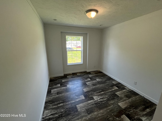 6243 NC Highway 58, Stantonsburg, NC 27883 - unfurnished room featuring a textured ceiling, dark wood-style flooring, baseboards, and ornamental molding