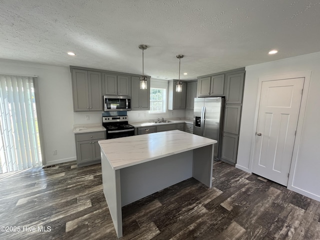 6243 NC Highway 58, Stantonsburg, NC 27883 - kitchen featuring gray cabinets, stainless steel appliances, a textured ceiling, dark wood-type flooring, and recessed lighting