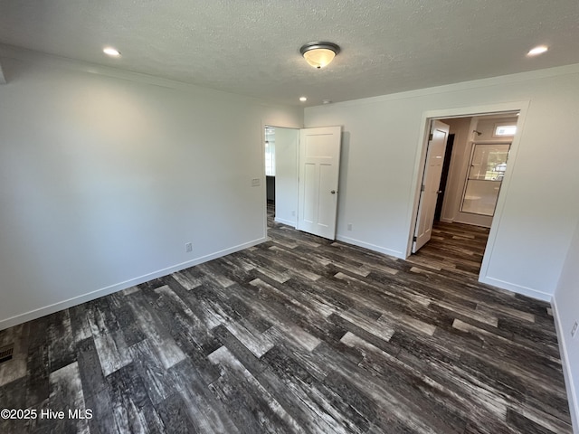 6243 NC Highway 58, Stantonsburg, NC 27883 - unfurnished bedroom with dark wood finished floors, a textured ceiling, baseboards, and recessed lighting