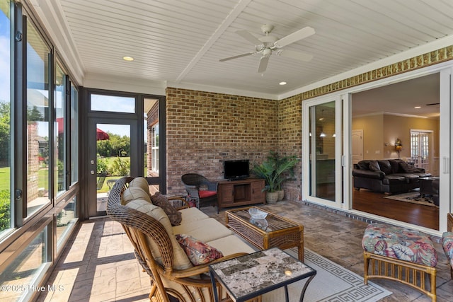 sunroom featuring an outdoor hangout area and a ceiling fan