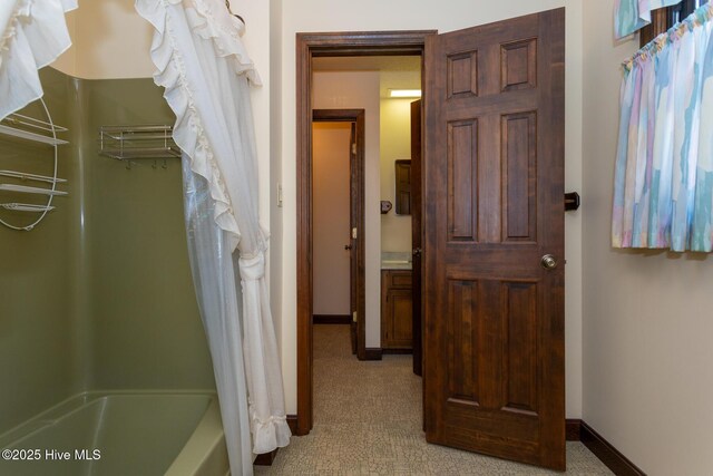 154 Overlook Dr, West End, NC 27376 - unfurnished bedroom with light carpet, baseboards, a walk in closet, and a textured ceiling