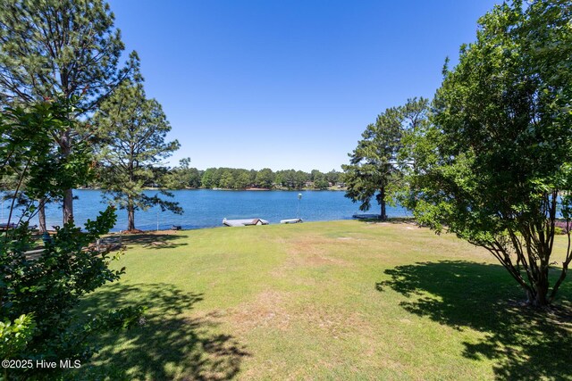 154 Overlook Dr, West End, NC 27376 - view of property exterior with fence, an attached garage, asphalt driveway, and a shingled roof