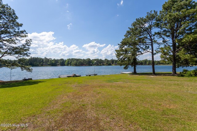 154 Overlook Dr, West End, NC 27376 - view of front facade with a wooden deck and a front lawn
