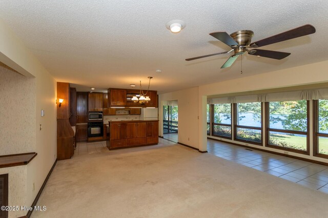 154 Overlook Dr, West End, NC 27376 - kitchen with oven, freestanding refrigerator, open shelves, stainless steel microwave, and a textured ceiling