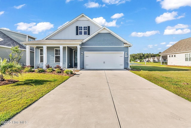 craftsman-style house featuring board and batten siding, a front lawn, a porch, and driveway