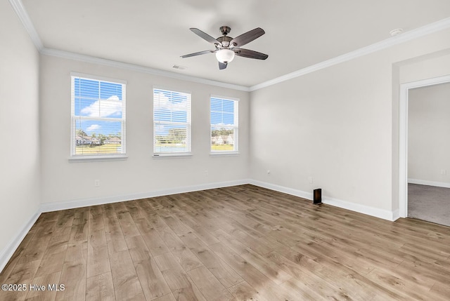 spare room with crown molding, light wood finished floors, ceiling fan, and baseboards