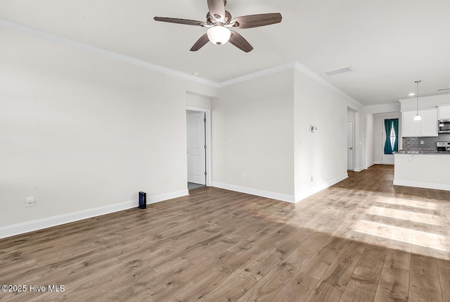 unfurnished living room with light wood-style flooring, ceiling fan, ornamental molding, and baseboards