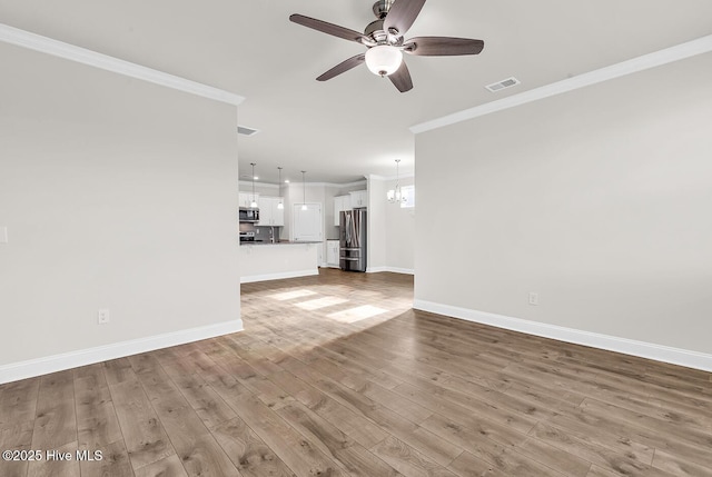 unfurnished living room featuring crown molding, a ceiling fan, baseboards, and wood finished floors