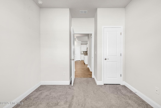unfurnished bedroom with carpet flooring and baseboards