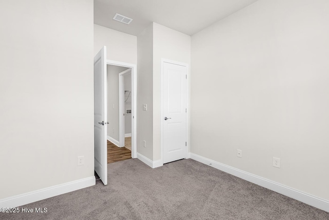 unfurnished bedroom featuring carpet and baseboards