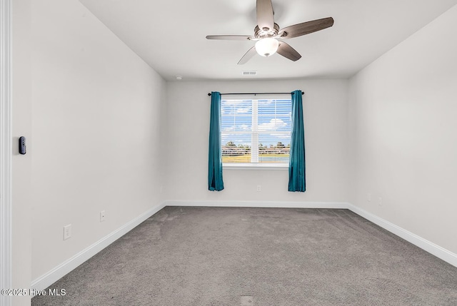 carpeted empty room with a ceiling fan and baseboards