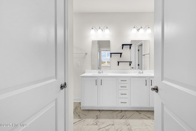 bathroom with marble finish floors and double vanity