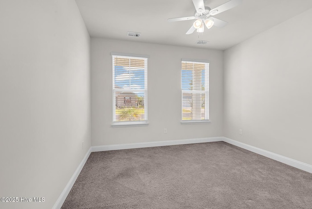 carpeted spare room with baseboards and ceiling fan