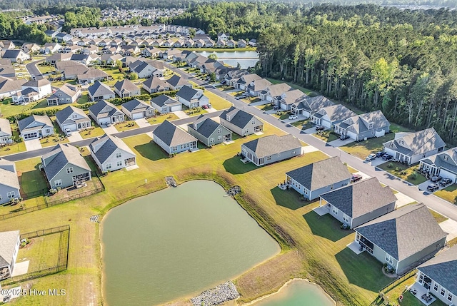 aerial perspective of suburban area featuring a nearby body of water