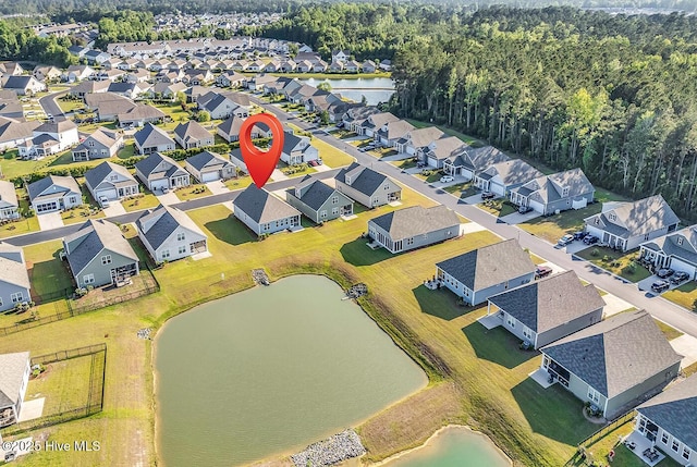 aerial perspective of suburban area with a large body of water