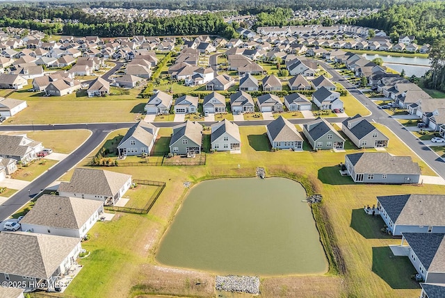 aerial view of residential area featuring a large body of water