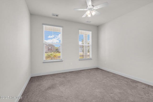 empty room featuring carpet, baseboards, and a ceiling fan