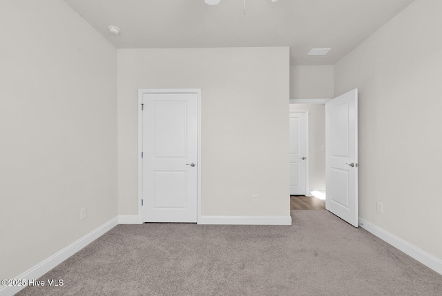 unfurnished bedroom featuring carpet and baseboards