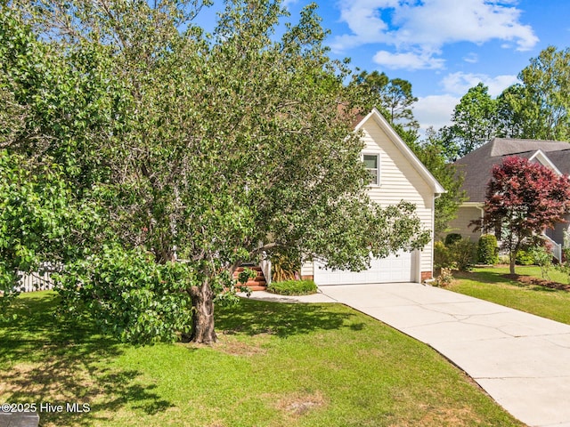 obstructed view of property with concrete driveway, a garage, and a front yard