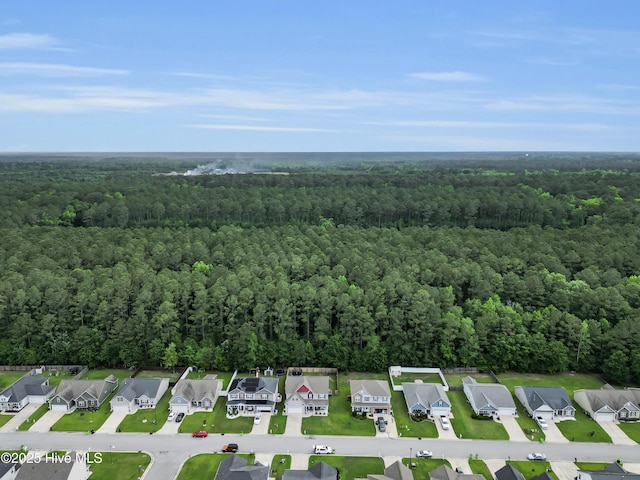 aerial overview of property's location featuring a heavily wooded area and nearby suburban area