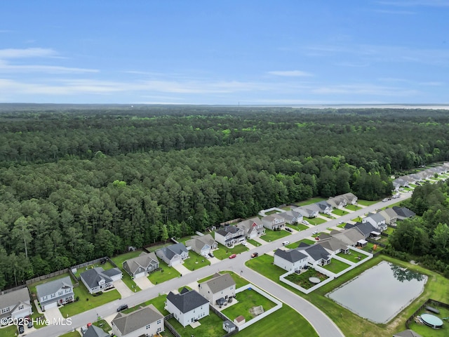 aerial view of residential area with a heavily wooded area
