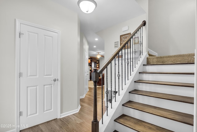 stairs featuring wood finished floors, recessed lighting, baseboards, and ceiling fan