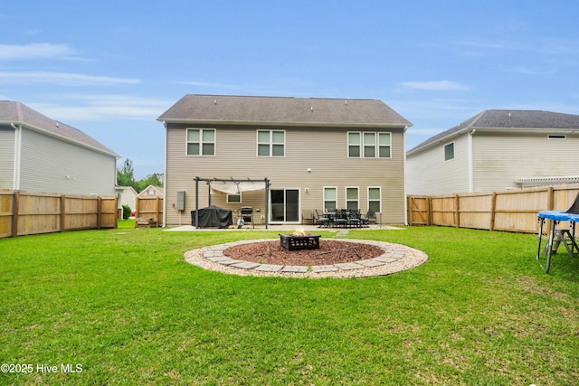 rear view of property with a fire pit and a patio area