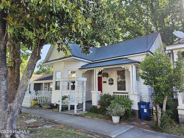 view of front facade with covered porch and metal roof
