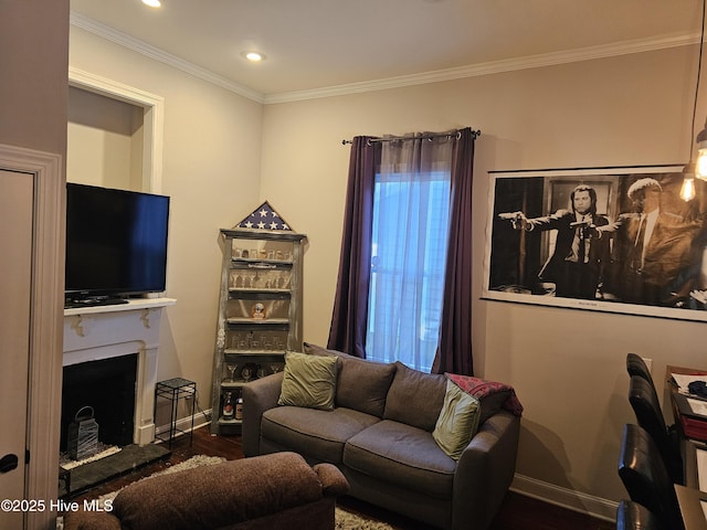 living room featuring a fireplace with raised hearth, wood finished floors, ornamental molding, baseboards, and recessed lighting