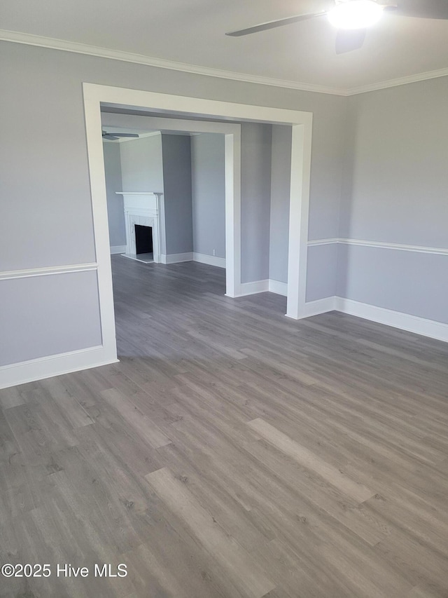 4384 Race Track Rd, Grifton, NC 28530 - empty room with wood finished floors, baseboards, crown molding, ceiling fan, and a fireplace
